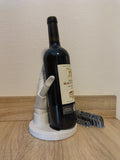 Porte-bouteille sculptural La Main du Sommelier en impression 3D couleur marbre moucheté maintenant une bouteille de vin en équilibre.